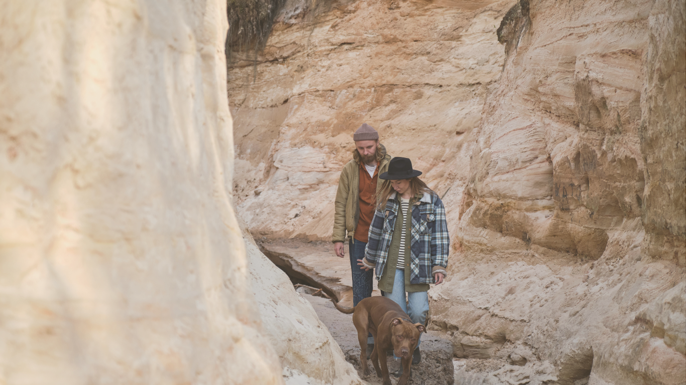 A couple exploring rocky terrain during an off-grid RV travel adventure, representing the spirit of RV boondocking freedom.